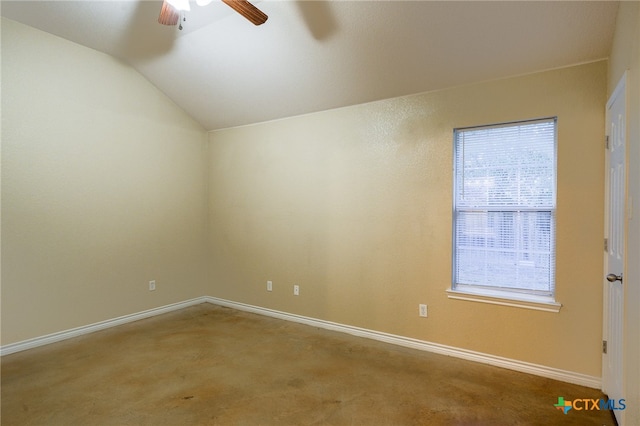 carpeted spare room featuring ceiling fan and vaulted ceiling