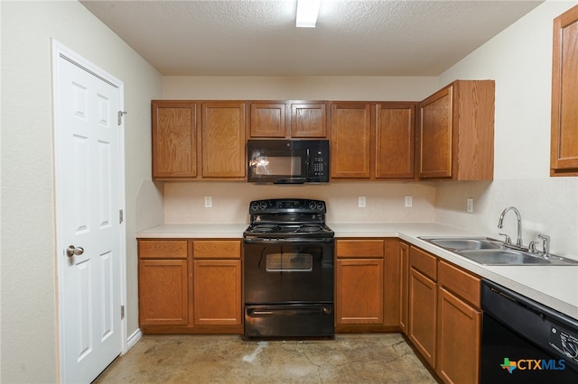 kitchen featuring a textured ceiling, sink, and black appliances