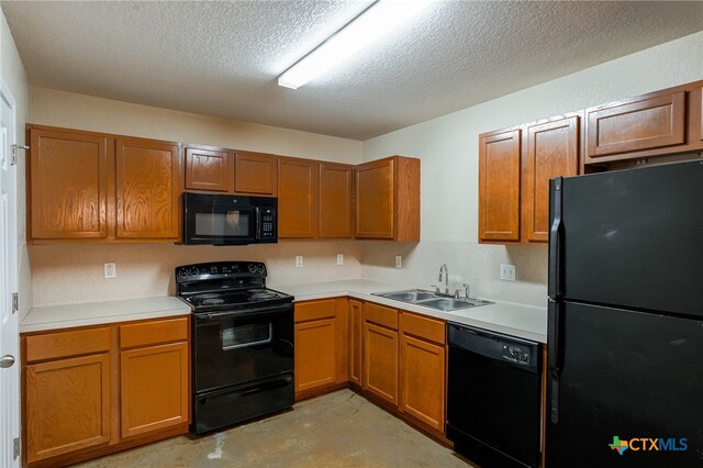 kitchen with a textured ceiling, sink, and black appliances