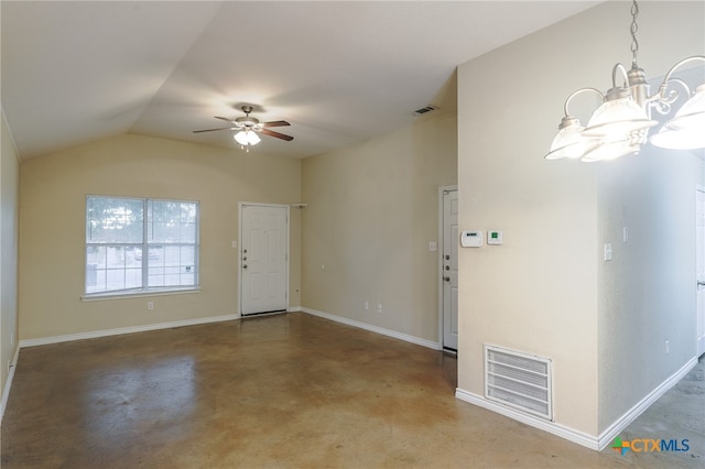 entryway with ceiling fan with notable chandelier, concrete floors, and lofted ceiling