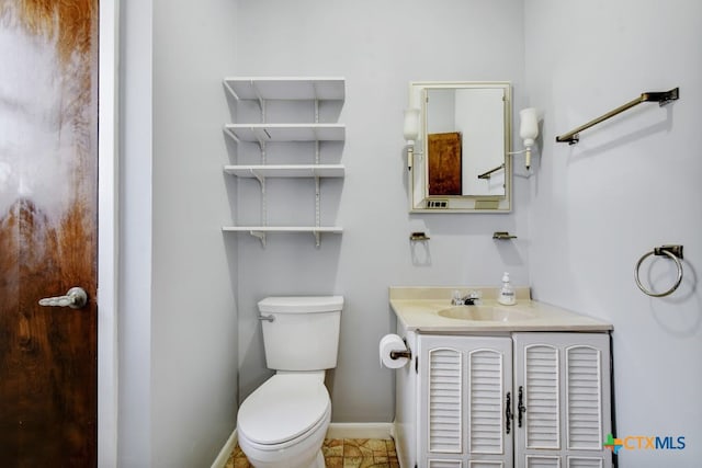 bathroom featuring vanity, tile patterned floors, and toilet