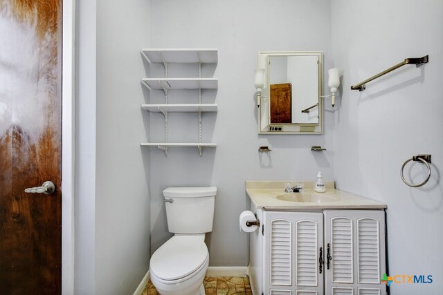 bathroom featuring vanity, tile patterned floors, and toilet