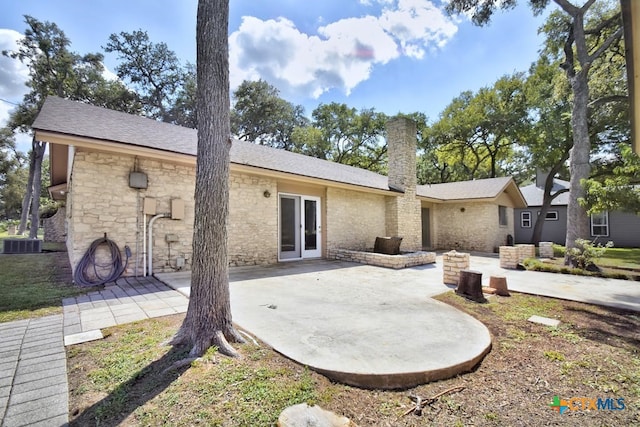 rear view of property with cooling unit, a patio, and french doors