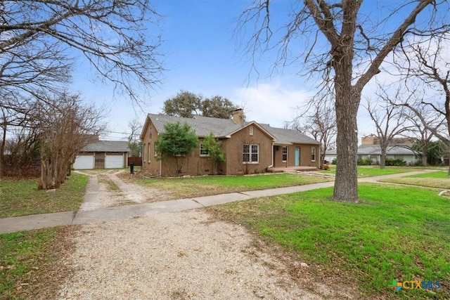 view of front of home with a garage and a front lawn