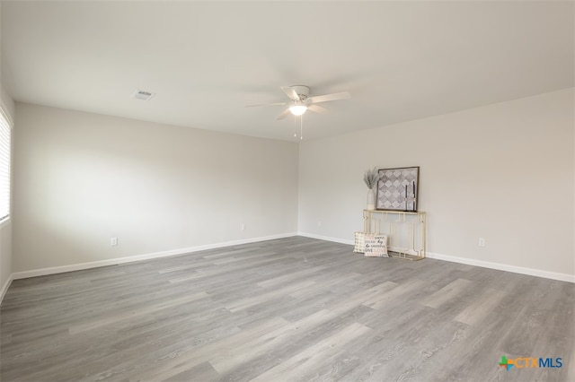 spare room featuring hardwood / wood-style floors and ceiling fan