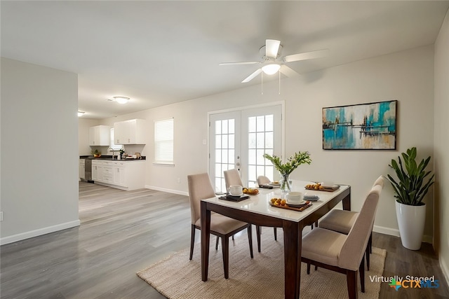 dining space featuring ceiling fan, light hardwood / wood-style flooring, french doors, and sink