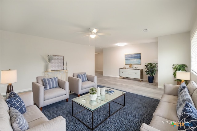 living room featuring ceiling fan and light hardwood / wood-style floors