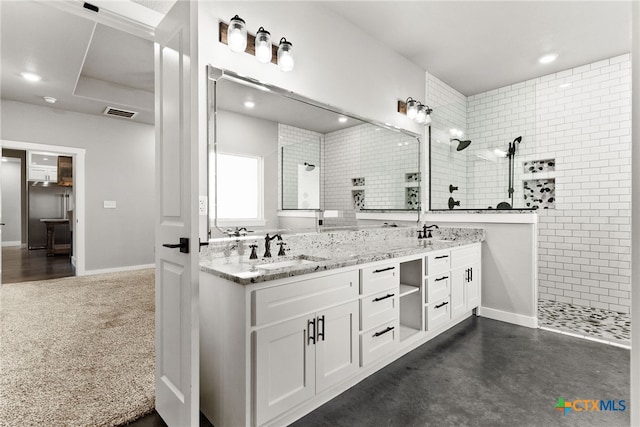 bathroom featuring vanity and tiled shower