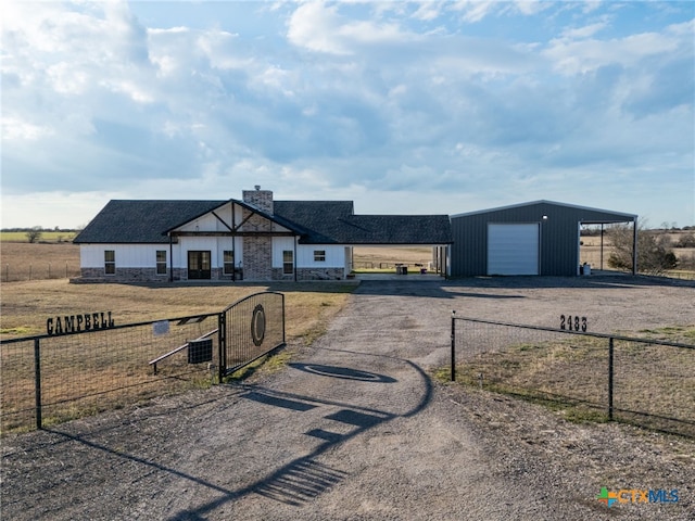 view of front facade with a carport, a garage, and an outdoor structure