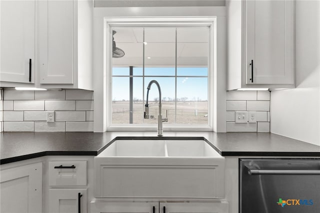 kitchen with white cabinetry, sink, backsplash, and stainless steel dishwasher