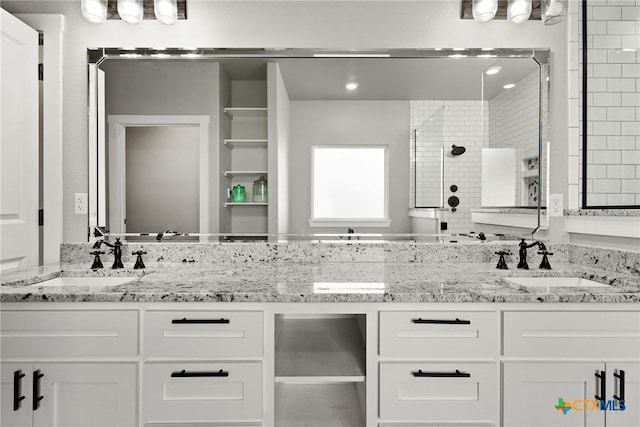 bathroom with vanity and a shower with shower door