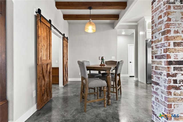 dining area with beam ceiling and a barn door