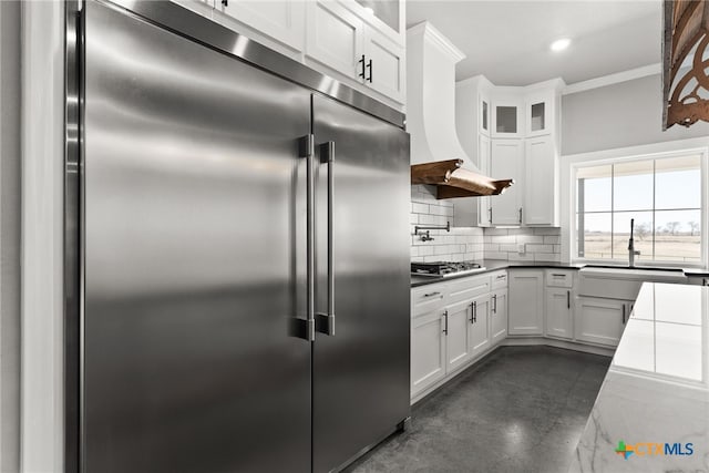 kitchen featuring crown molding, decorative backsplash, white cabinets, and appliances with stainless steel finishes