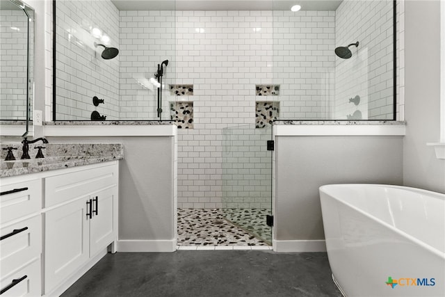 bathroom with plus walk in shower, vanity, and concrete floors