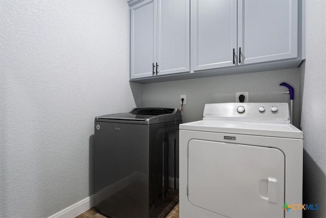 7516 Hardin Dr, Temple, TX 76502 - laundry room with cabinet space, separate washer and dryer, baseboards, a textured wall, and wood finished floors