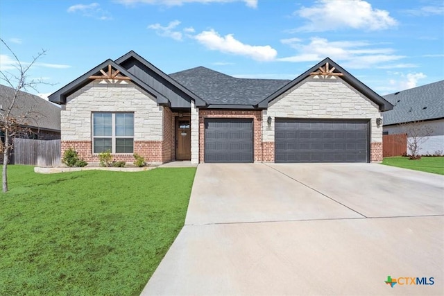 7516 Hardin Dr, Temple, TX 76502 - view of front of house with an attached garage, driveway, stone siding, and brick siding