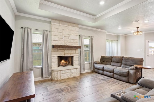 7516 Hardin Dr, Temple, TX 76502 - living area with a fireplace, a chandelier, crown molding, a raised ceiling, and recessed lighting