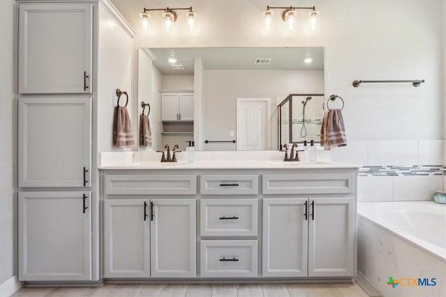 7516 Hardin Dr, Temple, TX 76502 - full bath with double vanity, a garden tub, and a shower with door