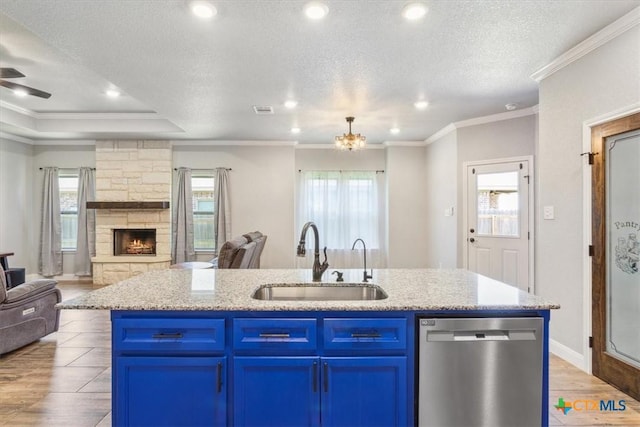 7516 Hardin Dr, Temple, TX 76502 - kitchen with dishwasher, a sink, open floor plan, blue cabinets, and recessed lighting