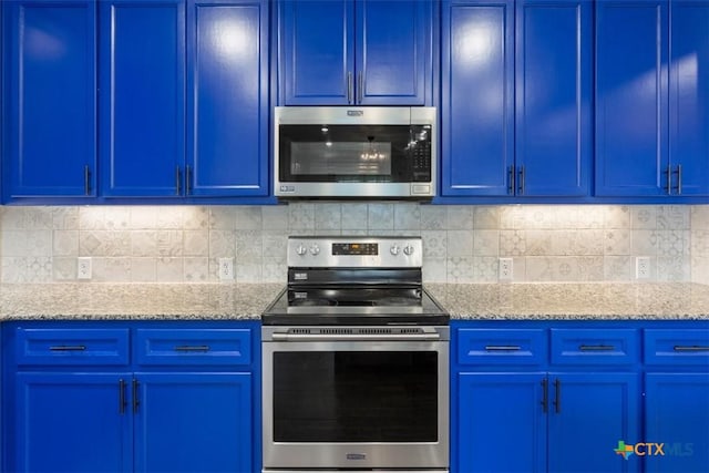 7516 Hardin Dr, Temple, TX 76502 - kitchen with stainless steel appliances, blue cabinetry, light stone counters, and decorative backsplash