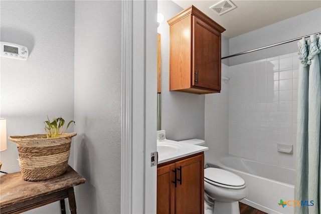 full bathroom featuring hardwood / wood-style floors, vanity, toilet, and shower / bath combo with shower curtain