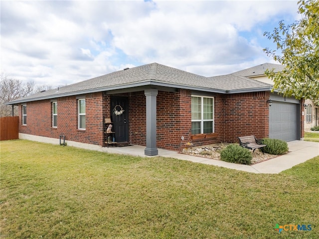 single story home with a garage and a front lawn