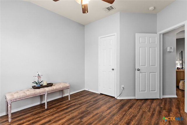 unfurnished bedroom featuring dark hardwood / wood-style floors and ceiling fan