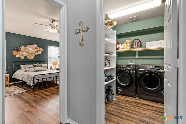 laundry room with ceiling fan, washer and clothes dryer, and dark hardwood / wood-style floors