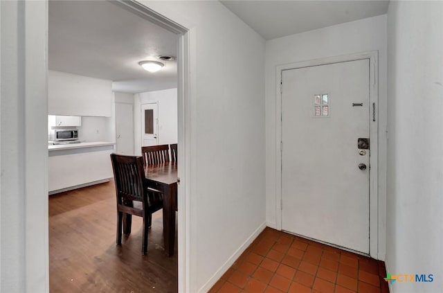 2307 E Airline Rd, Victoria, TX 77901 - entrance foyer featuring baseboards and dark tile patterned flooring