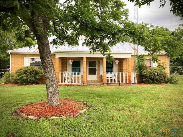 single story home with covered porch and a front yard