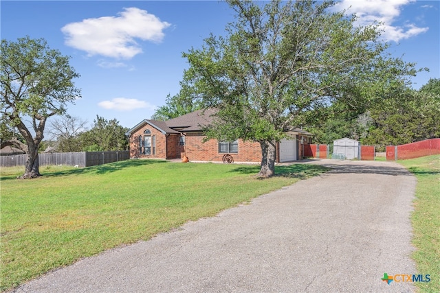 single story home featuring a front yard and a garage