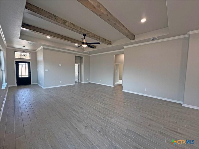 unfurnished living room with beam ceiling, wood finished floors, visible vents, and baseboards