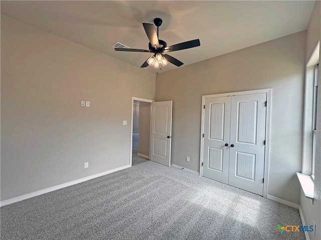 unfurnished bedroom featuring visible vents, baseboards, a ceiling fan, carpet flooring, and a closet