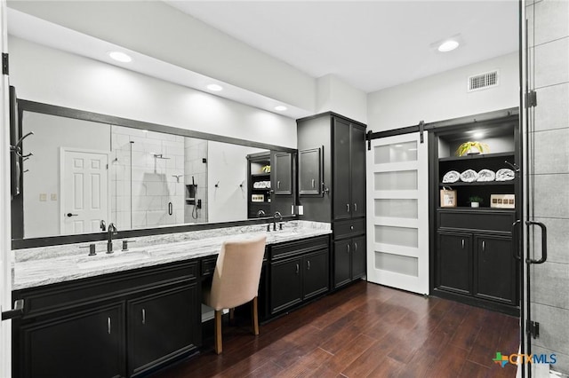 504 Masters Dr, Victoria, TX 77904 - bathroom featuring double vanity, a shower stall, wood finished floors, and recessed lighting