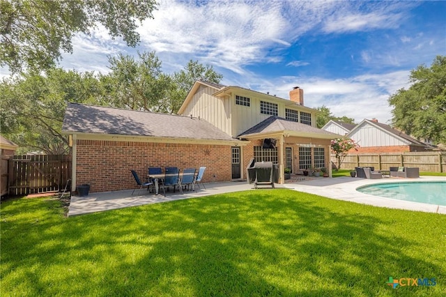 504 Masters Dr, Victoria, TX 77904 - back of property with brick siding, a patio, a fenced backyard, and board and batten siding