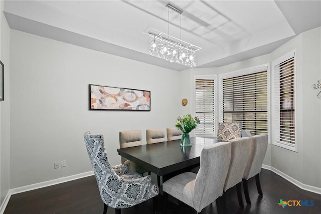 504 Masters Dr, Victoria, TX 77904 - dining area featuring a tray ceiling and dark wood finished floors