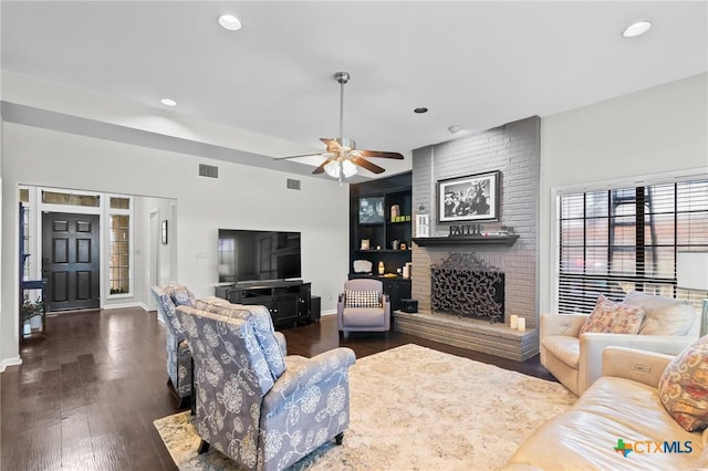 504 Masters Dr, Victoria, TX 77904 - living area featuring a ceiling fan, dark wood-style flooring, recessed lighting, and a brick fireplace
