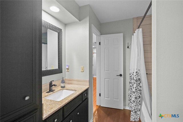 504 Masters Dr, Victoria, TX 77904 - bathroom with wood finished floors, vanity, and a shower with shower curtain