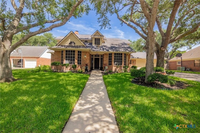 504 Masters Dr, Victoria, TX 77904 - traditional-style home with a front lawn, brick siding, and a chimney