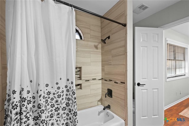 504 Masters Dr, Victoria, TX 77904 - full bath with shower / bathtub combination with curtain, healthy amount of natural light, and wood finished floors