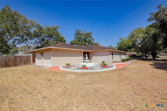 ranch-style home with a garage and a front lawn