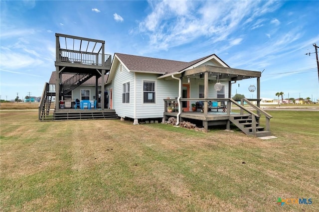 11 Enchanted Ln, Port Lavaca, TX 77979 - view of front facade featuring stairs, a front lawn, and a deck