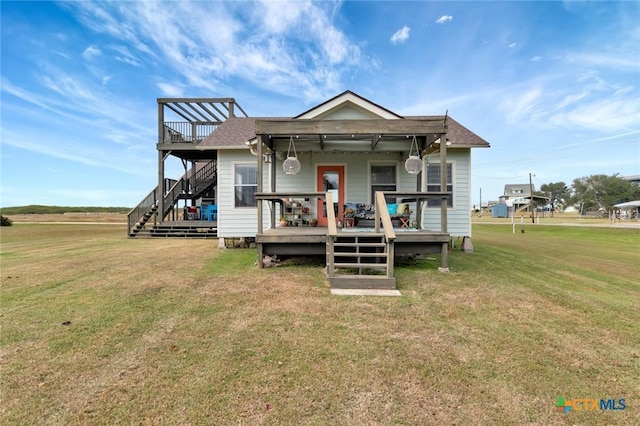 11 Enchanted Ln, Port Lavaca, TX 77979 - rear view of house with stairway, a yard, and a wooden deck