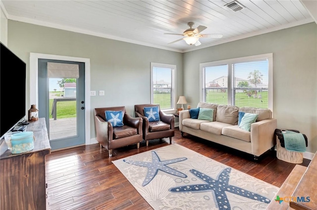 11 Enchanted Ln, Port Lavaca, TX 77979 - living area with crown molding, plenty of natural light, dark wood-style floors, and a ceiling fan