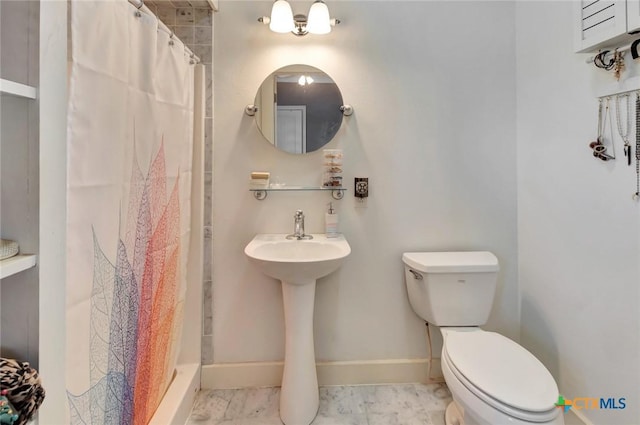 11 Enchanted Ln, Port Lavaca, TX 77979 - bathroom with marble look tile flooring and a shower with shower curtain