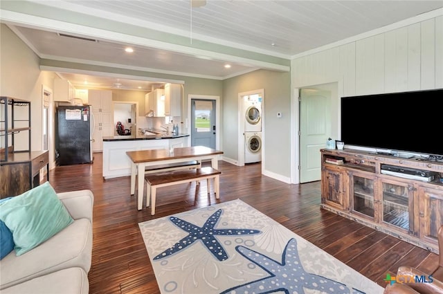 11 Enchanted Ln, Port Lavaca, TX 77979 - living room with stacked washer and clothes dryer, dark wood finished floors, ornamental molding, and recessed lighting