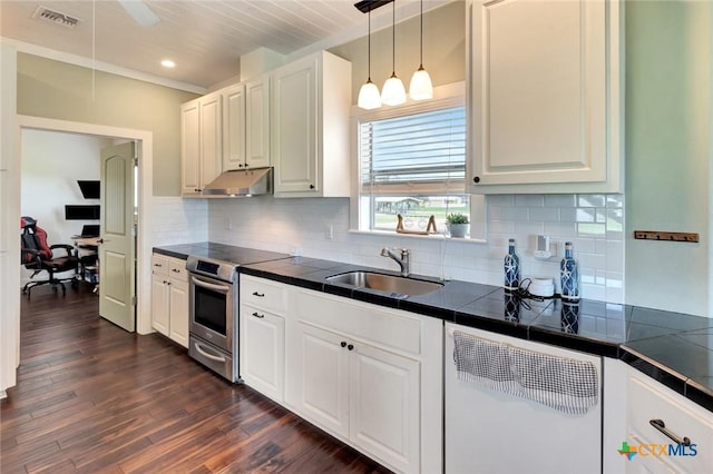 11 Enchanted Ln, Port Lavaca, TX 77979 - kitchen with electric stove, under cabinet range hood, dishwasher, tile counters, and white cabinetry