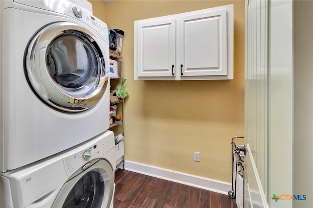 11 Enchanted Ln, Port Lavaca, TX 77979 - washroom with stacked washer / drying machine, dark wood-type flooring, and cabinet space
