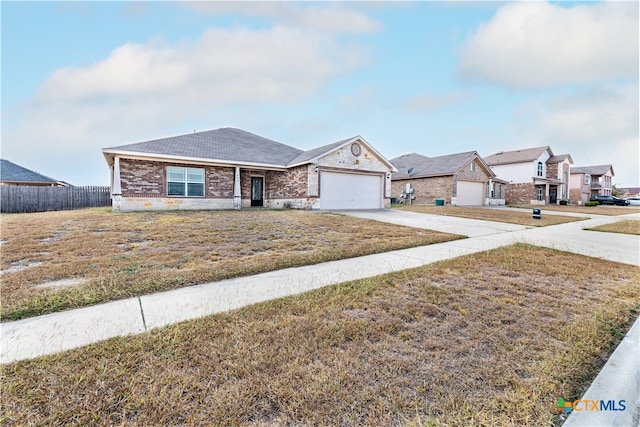 single story home with a garage and a front lawn