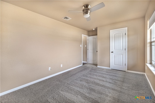 unfurnished bedroom with ceiling fan and carpet